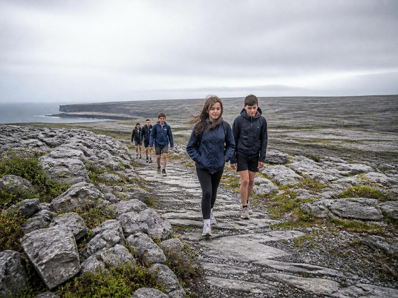 Students walking a limestone trail across the Burren